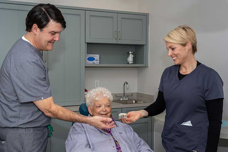 doctor Leo Regan with a full arch dental implants patient