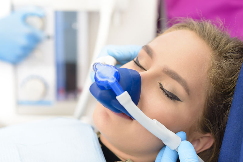 a dental implant patient during an inhaled sedation procedure